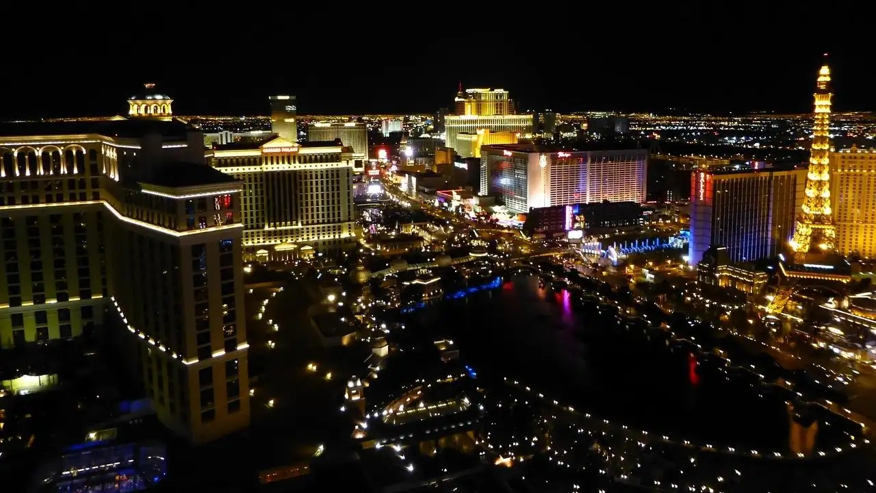 The Center Strip at night from above: lit resort towers, the Bellagio lake and the Eiffel Tower copy