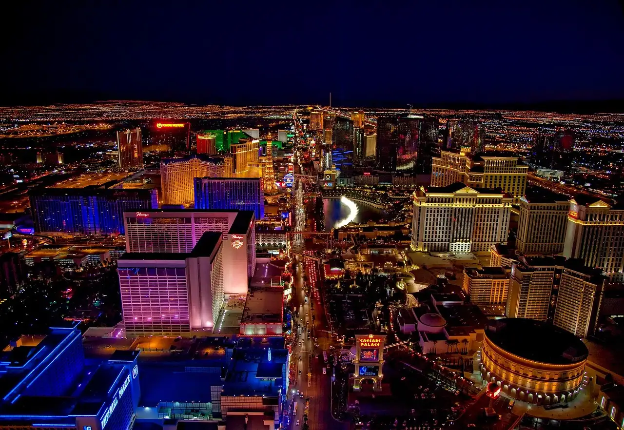 The Las Vegas Strip from above at night, resorts and traffic lit up