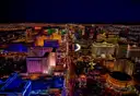 The Las Vegas Strip from above at night, resorts and traffic lit up