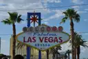 The Welcome to Fabulous Las Vegas sign between palm trees under a blue sky