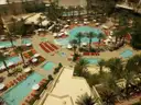 A Las Vegas resort pool deck from above, with several pools, palms and sun loungers