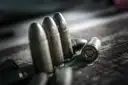 Close-up of bullets on a dark surface
