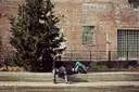 A couple sitting on steps beside a brick building