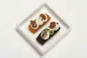 Two canapés on a small square white plate
