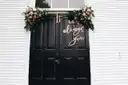 Black chapel doors framed with roses and the words It was always you