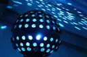 Round club light throwing blue dots across a ceiling
