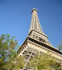 The Las Vegas Eiffel Tower seen from below through trees