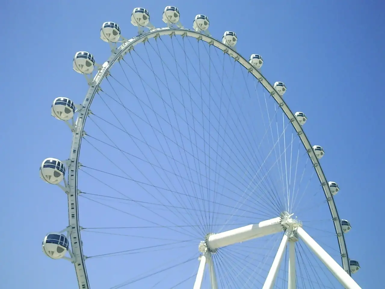 The High Roller wheel and its round cabins against a blue sky