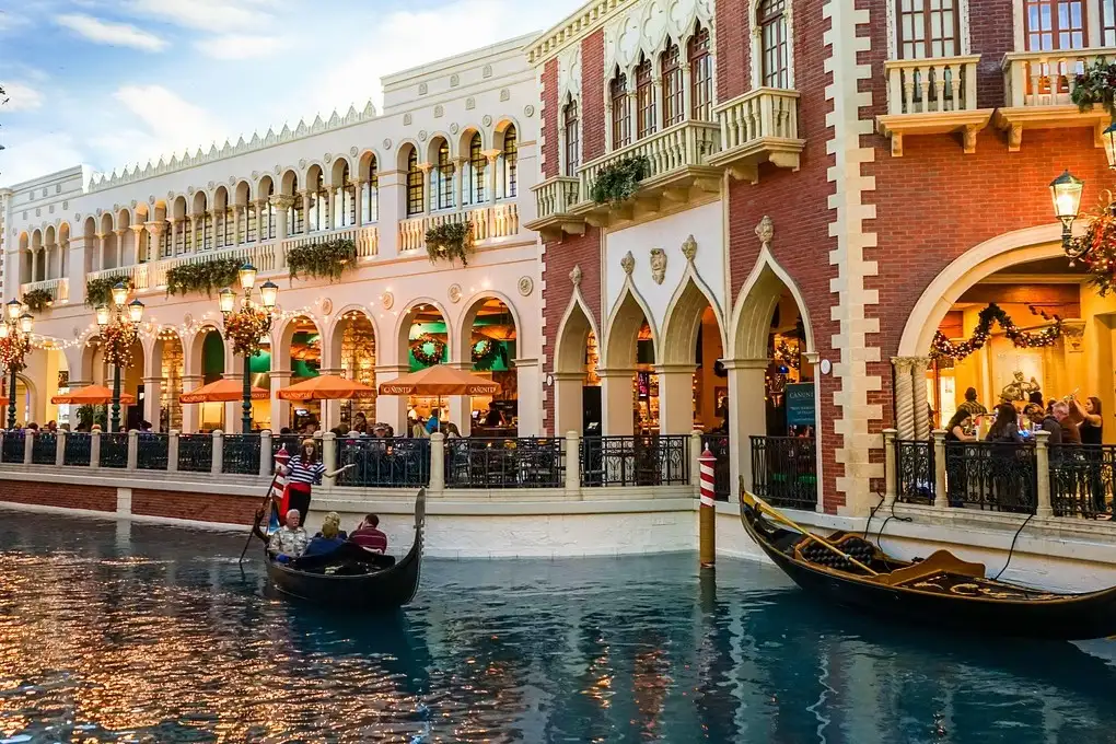 Gondolas on the indoor canal at The Venetian, Venetian-style facades under a painted sky