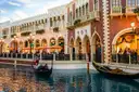 Gondolas on the indoor canal at The Venetian, Venetian-style facades under a painted sky