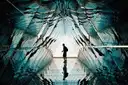 A silhouette walking through a mirrored art tunnel