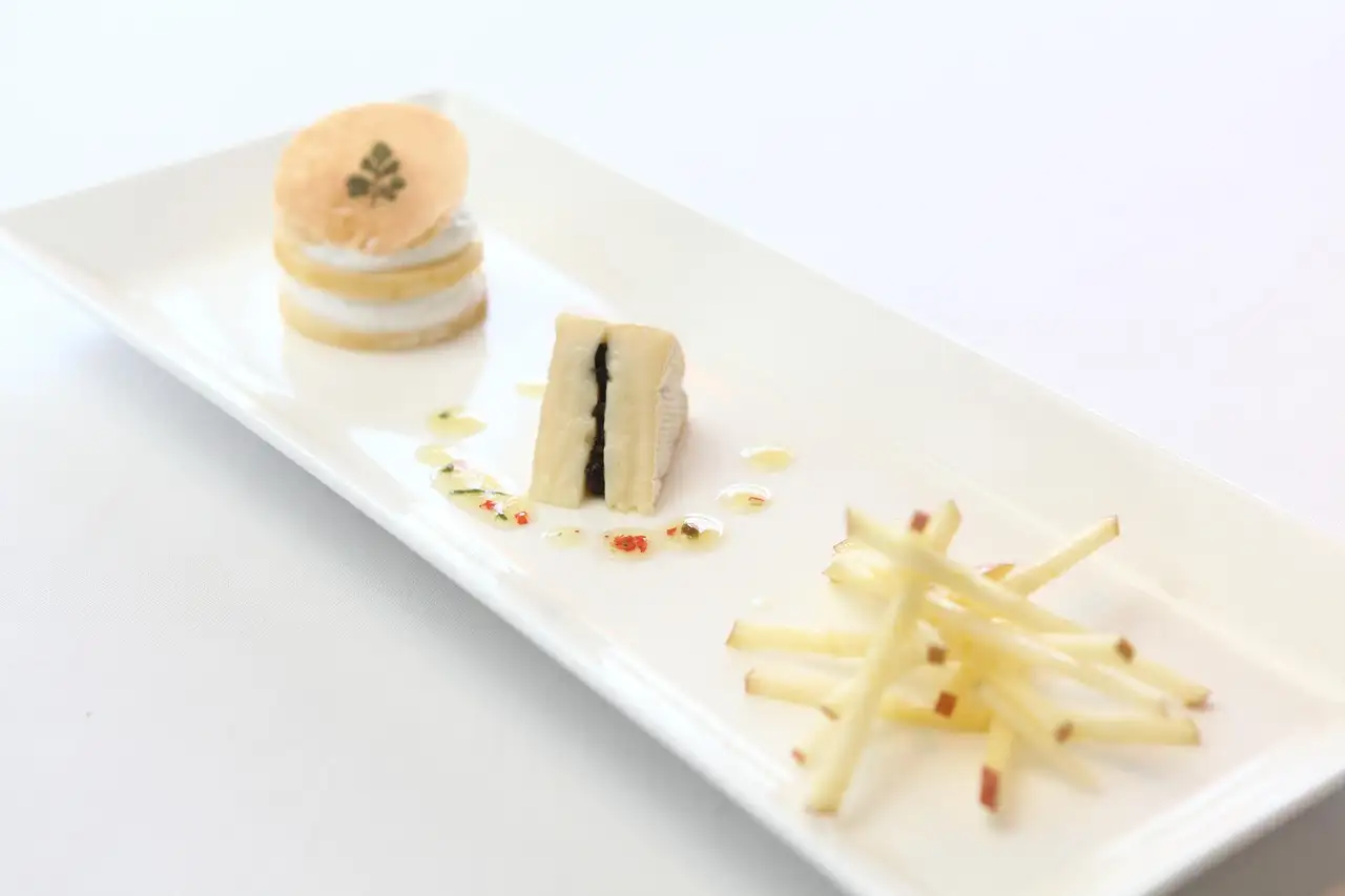 Long white plate with three small plated tastings