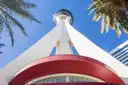 The base of the STRAT tower seen from below between palms