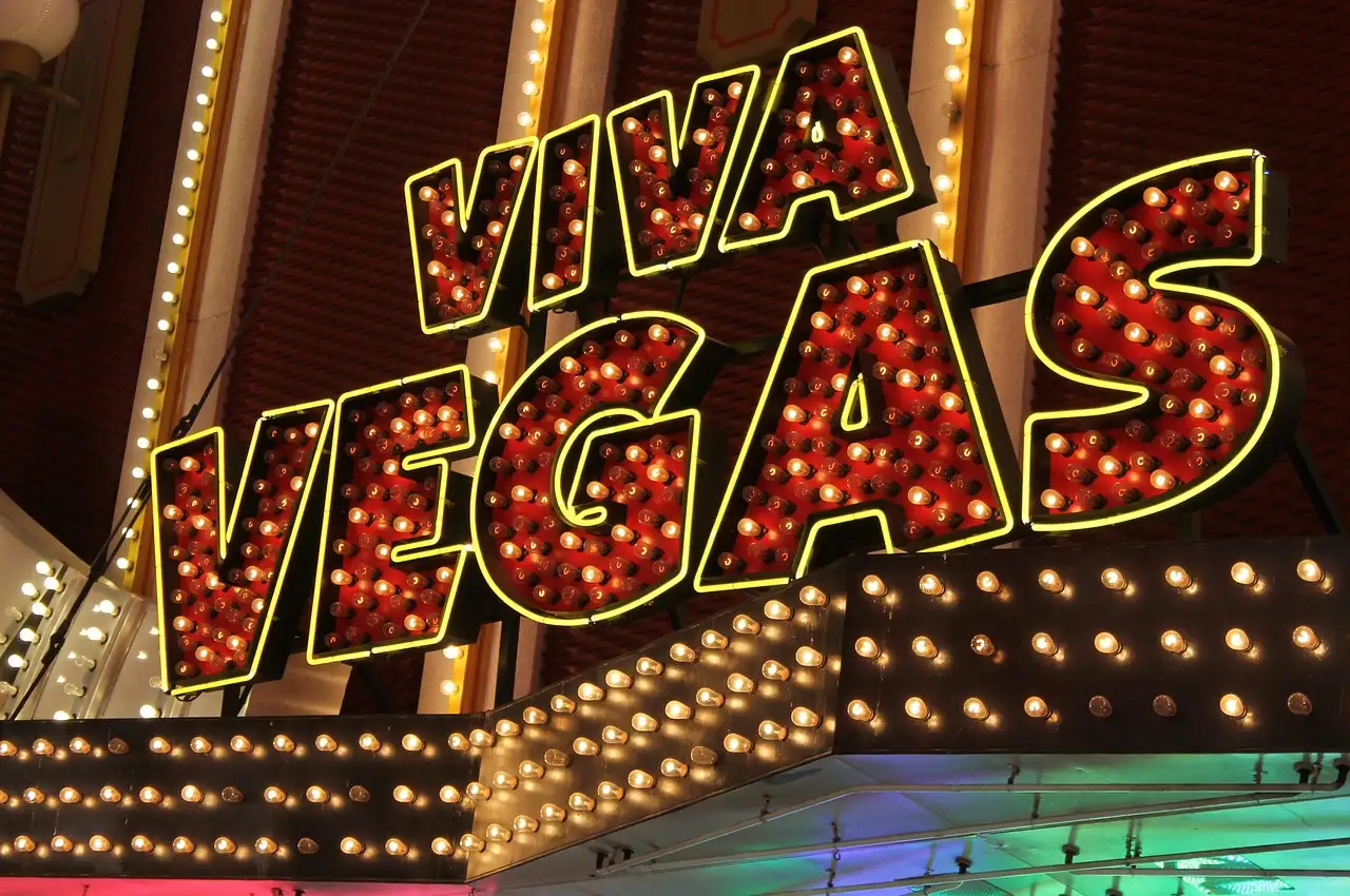 A VIVA VEGAS marquee sign in red bulbs and yellow neon
