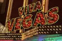 A VIVA VEGAS marquee sign in red bulbs and yellow neon