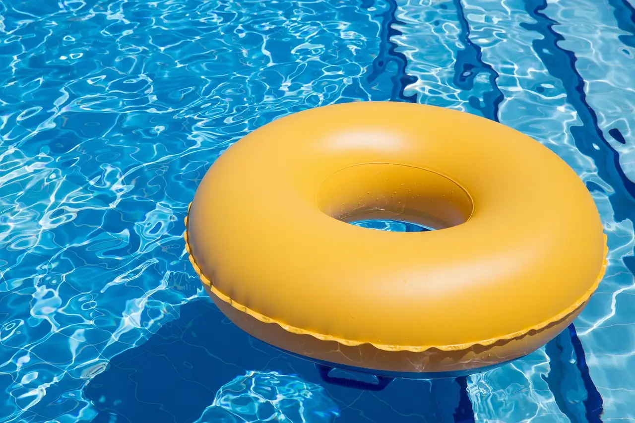 Yellow swim ring floating over pool lane lines