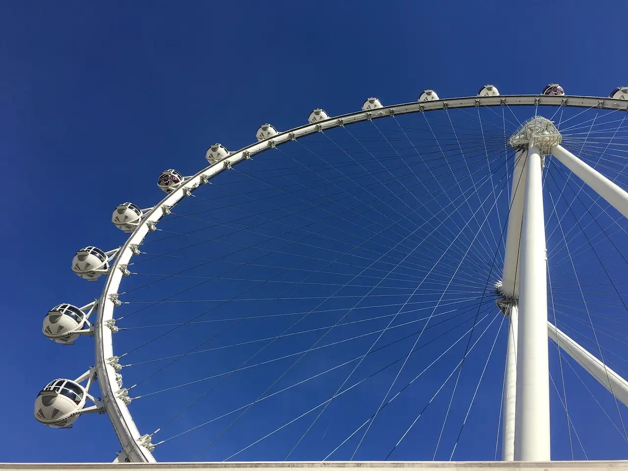 The High Roller observation wheel and its cabins against a deep blue sky in Las Vegas